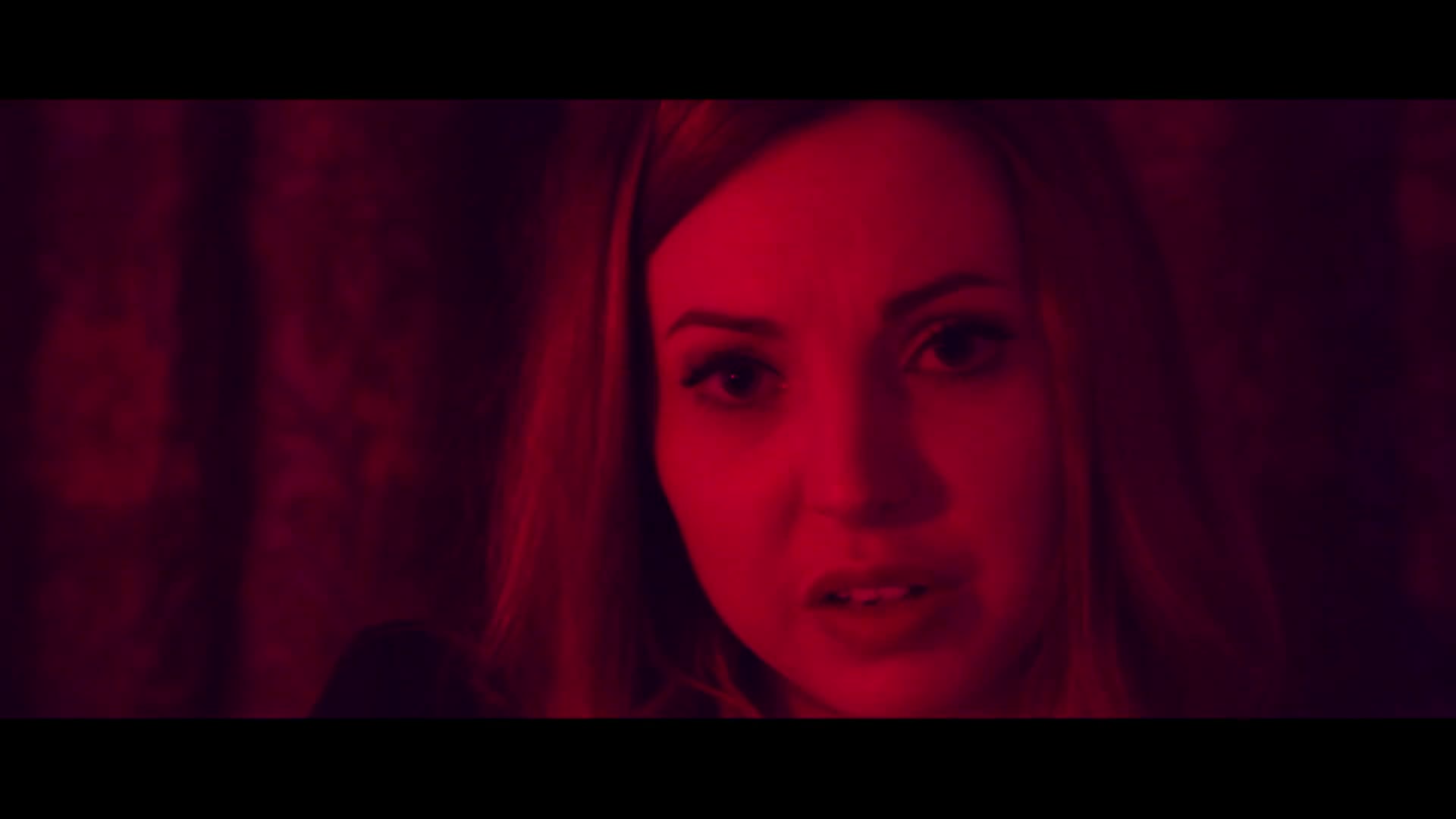Film shot with a red filter of a woman's face