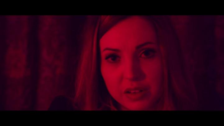 Film shot with a red filter of a woman's face