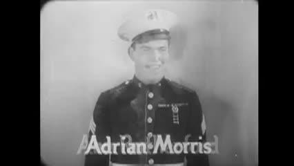black and white movie clip of a man dressed in a Marine uniform "Adrian Morris" at the bottom