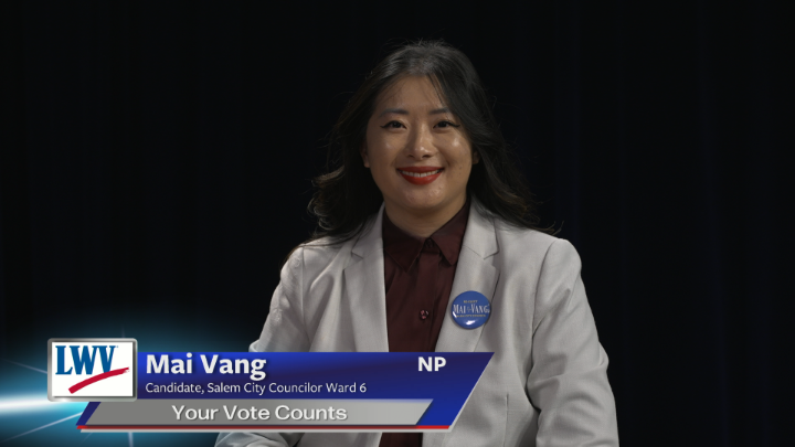 Black background. Woman with dark hair and grey suit jacket seated in the middle. Blue and grey lower thirds with white words: "Mai Vang Candidate, Salem City Councilor Ward 6 Your Vote Counts"