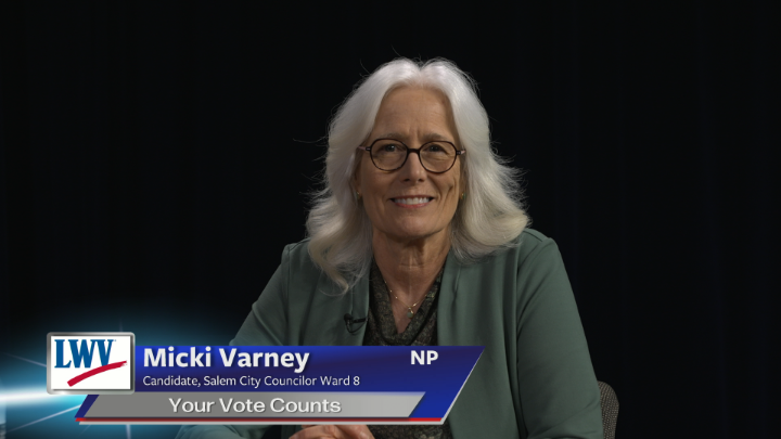 black background. Older woman in the center with a black shirt and green suit jacket. Blue and grey lower thirds with white words "Micki Varney Candidate, Salem City Councilor Ward 8 Your Vote Counts"