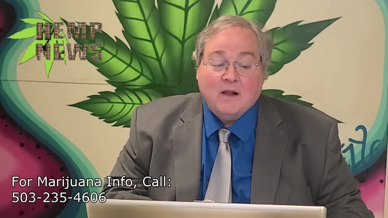 Man seated in front of a large green cannabis leaf, wearing a suit and glasses. The words "Breaking News" in the top left