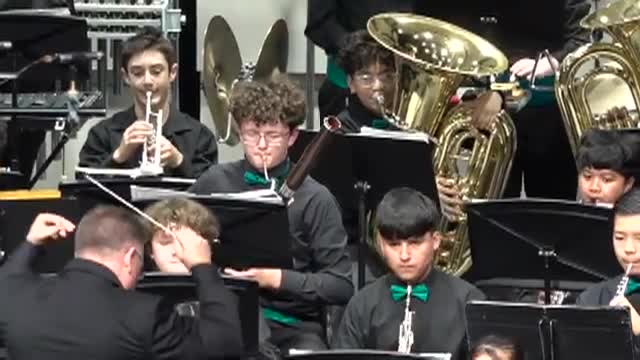 Students dressed in black playing band instruments
