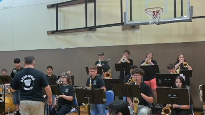 Students playing jazz instruments in a a gym