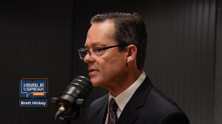 close up of a man in glasses behind a podcast mic with Let The Bible Speak logo in the bottom left