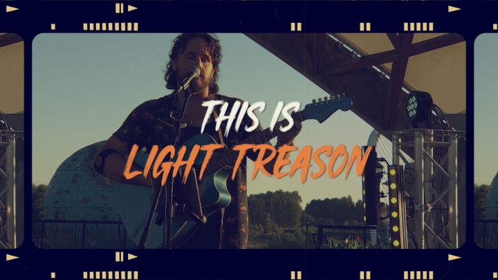 Singer with guitar in the background. White and orange words in the center: "This is Light Treason"