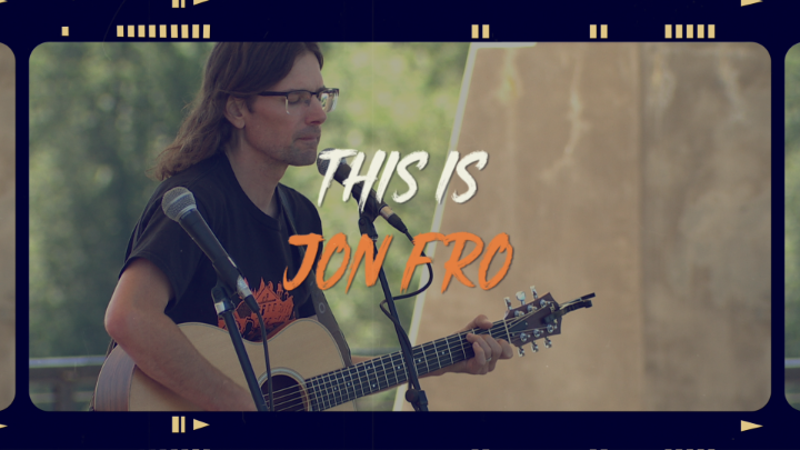 Man holding a guitar in the background with white and orange words in the middle: "This is Jon Fro"