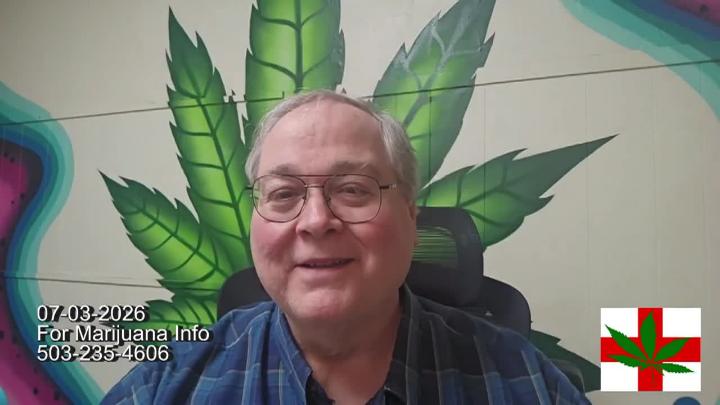 Man seated in a button up shirt with a green medical cannabis leaf painted behind him
