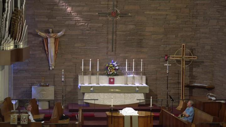 Alter and Jesus statue in front of a brick wall 