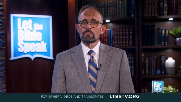 Man in a grey suit and glasses standing in the center. Book shelves in the back right. Blue "Let the Bible Speak" logo to the left