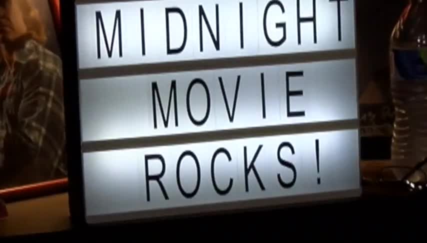 White marquee board with black words: Midnight Movie Rocks!