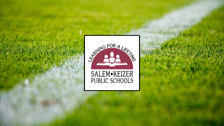 soccer field with white and maroon Salem Keizer Public Schools logo in the center