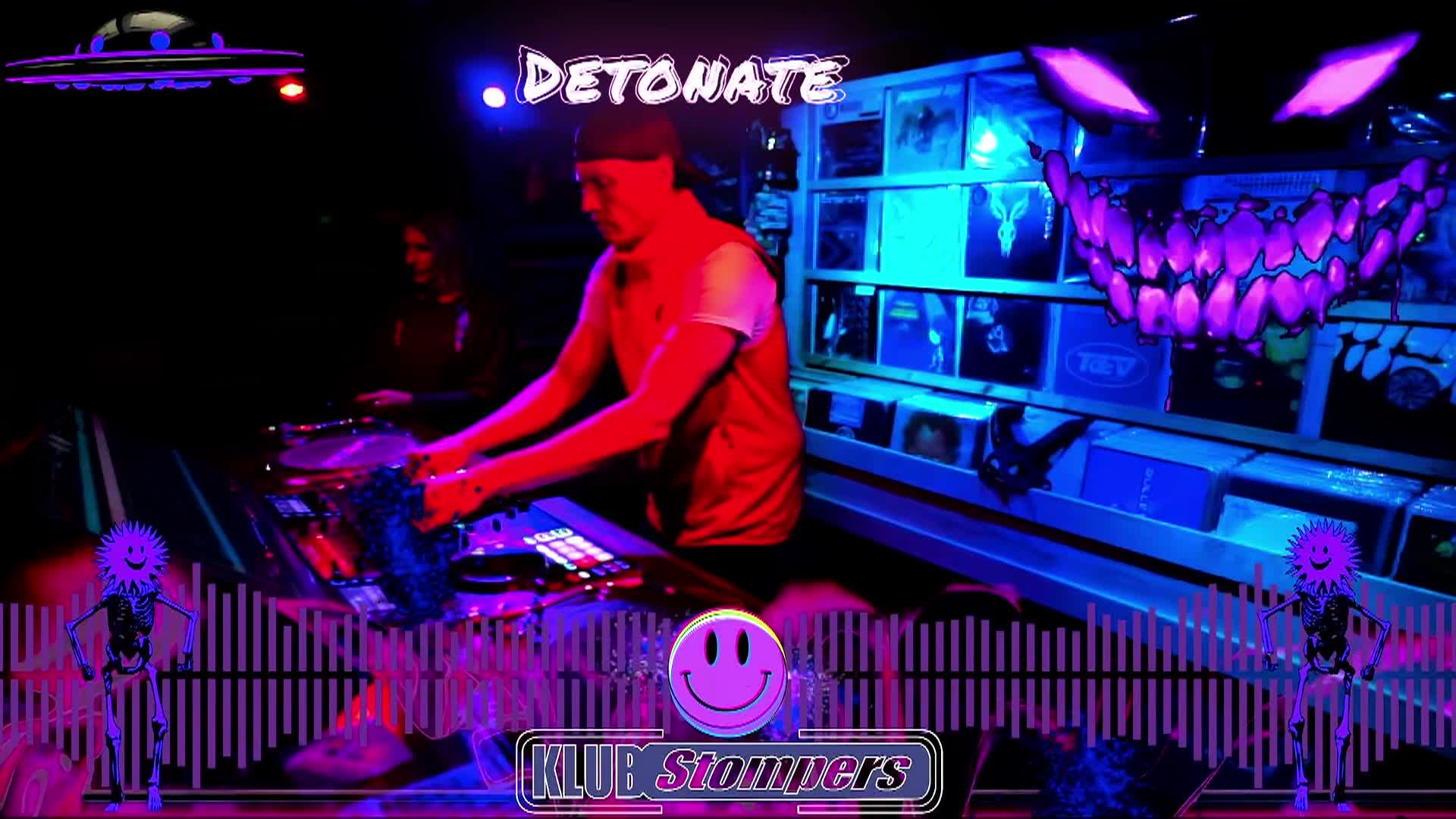 Glow in the dark colors. A dj and turntable to the left. Some sort of purple monster face in upper right corner. At the top, white word: Detonate