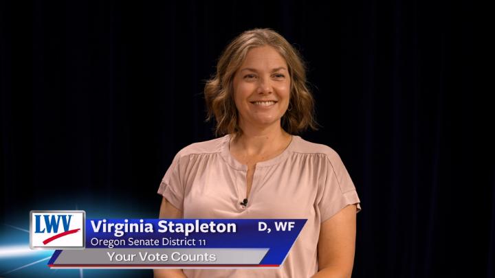 Black background. Man in a dark suit with a button up shirt and bowtie in the middle. Lower thirds to the bottom left with red, white and blue LWV logo. White words on a blue backgroundLWV Tom Andersen Oregon House District 19 Your Vote Counts D, I, WF
