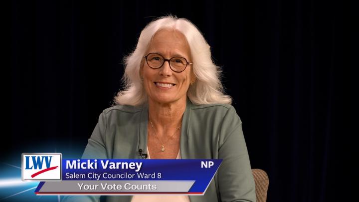 Black background. Woman in a green jacket and light colored shirt in the middle. Lower thirds to the bottom left with red, white and blue LWV logo. White words on a blue background: Micki Varney Salem City Councilor Ward 8 Your Vote Counts NP