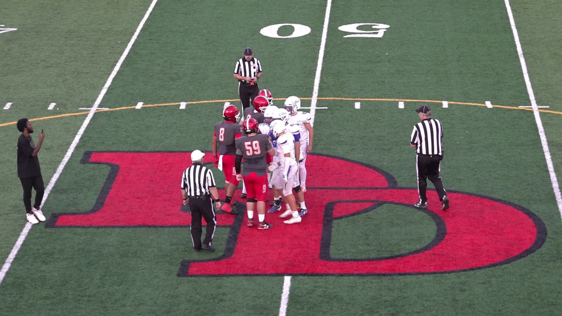 Football field with players in uniform on it
