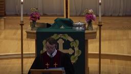 Lutheran priest standing in front of an alter at the front of the church.