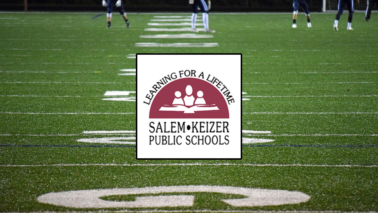Green football field with Salem Keizer Public Schools logo in center