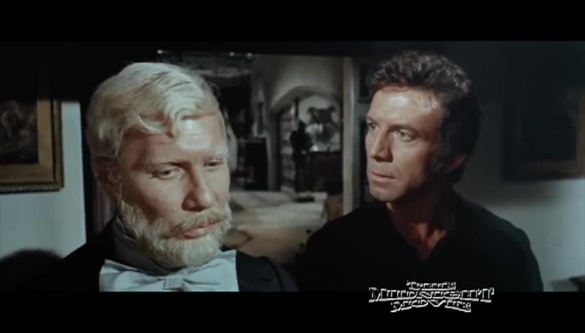 Older man with beard and mustache on the left, man in black on the right. The Midnight Movie logo in bottom right corner.