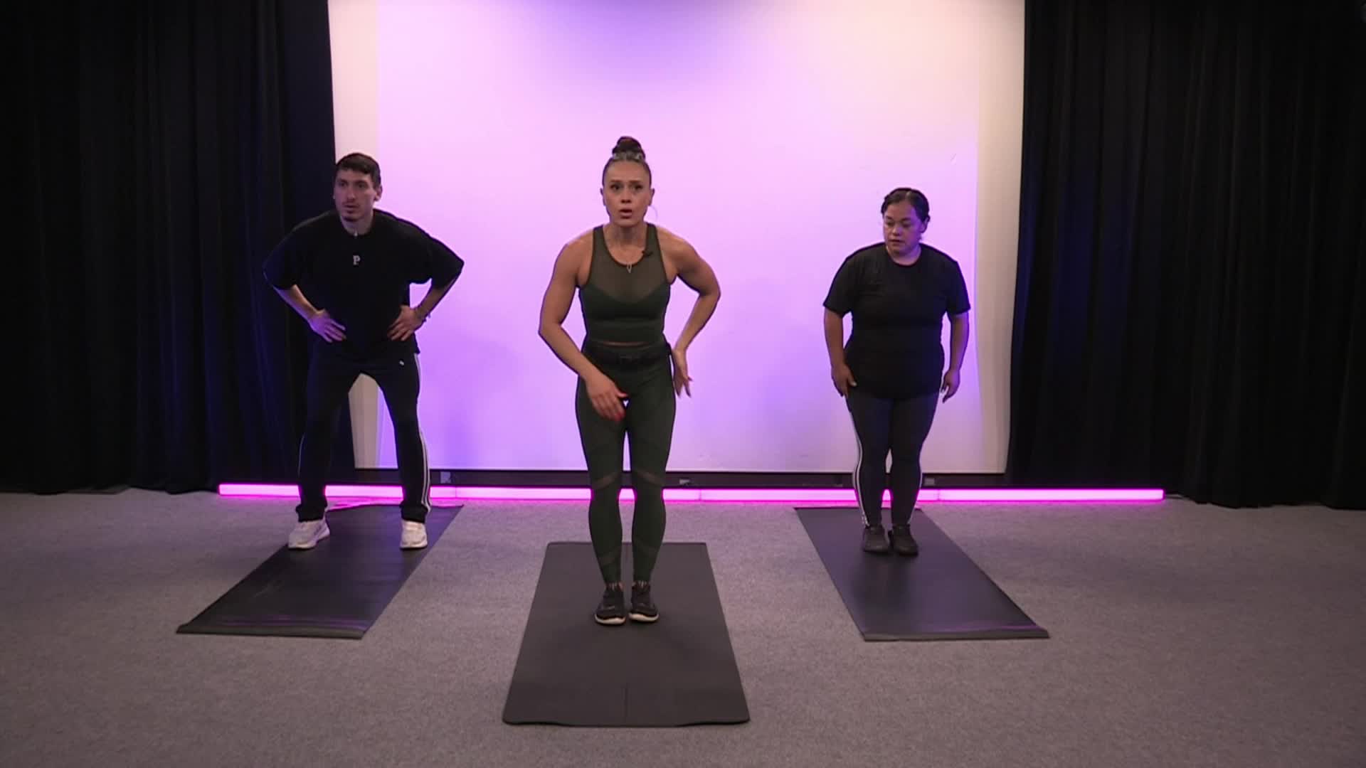 Purple lighted background with three people doing exercises